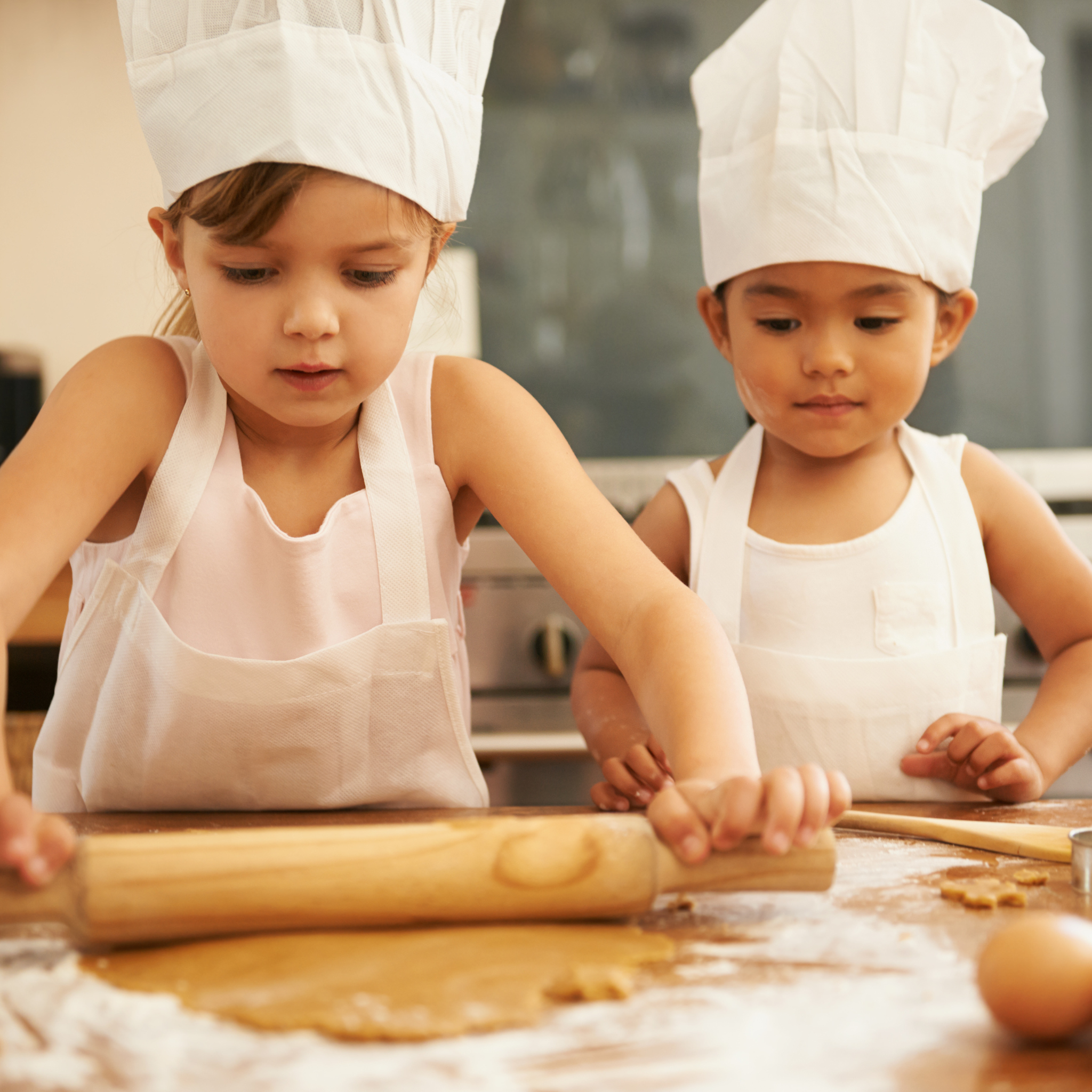 Child decorating sugar cookies with colorful icing